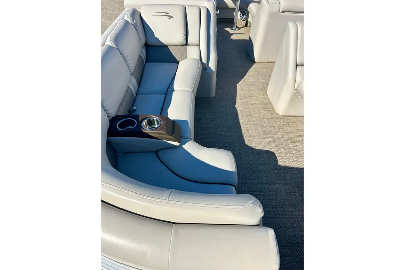 Slide: The Image of Luxurious seating on 2016 Bennington R21 boat with cup holders and plush upholstery. - 8