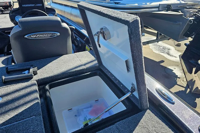 Slide: The Image of Open storage compartment on 2025 Phoenix 819 ZXL boat, featuring cushioned seating and modern design. - 12