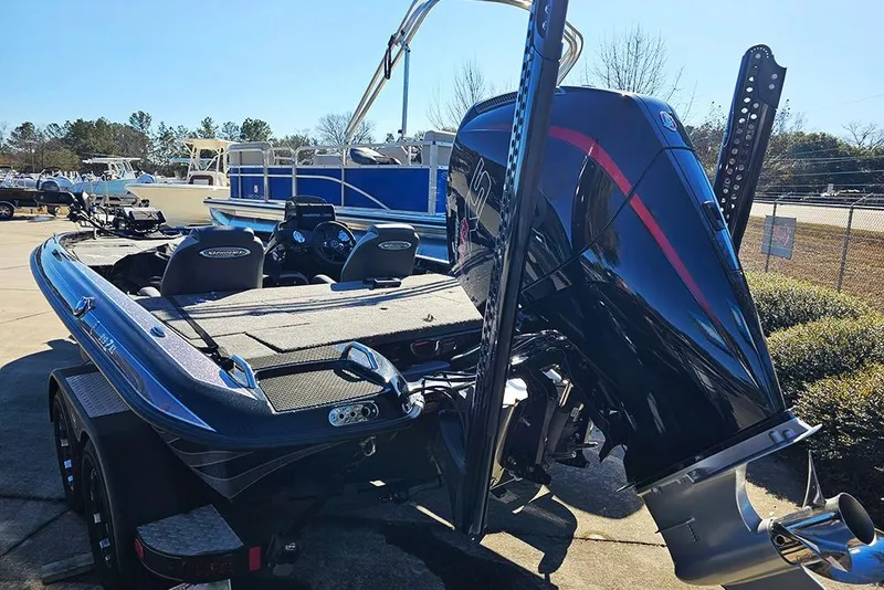Slide: The Image of 2025 Phoenix 819 ZXL boat with powerful outboard motor, parked outdoors. - 3