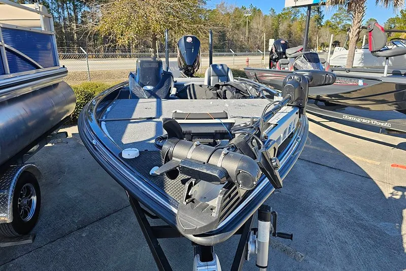 Slide: The Image of 2025 Phoenix 819 ZXL boat with advanced equipment, parked outdoors on a sunny day. - 5