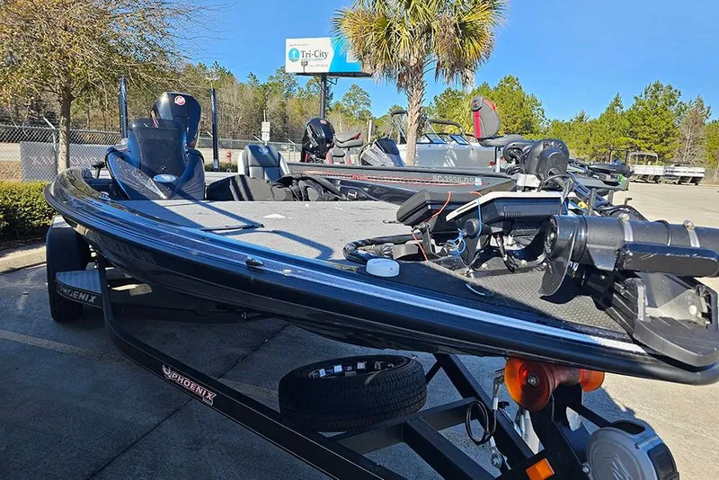 Slide: The Image of 2025 Phoenix 819 ZXL boat parked outdoors, featuring sleek design and advanced equipment. - 6
