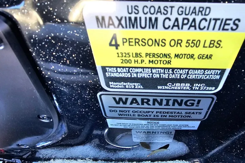 Slide: The Image of US Coast Guard capacity label on 2025 Phoenix 819 ZXL boat, 4 persons or 550 lbs. - 9