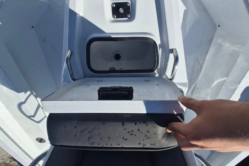 Slide: The Image of 2026 Xpress H20B Bay boat storage compartment with open lid, showcasing interior details. - 11