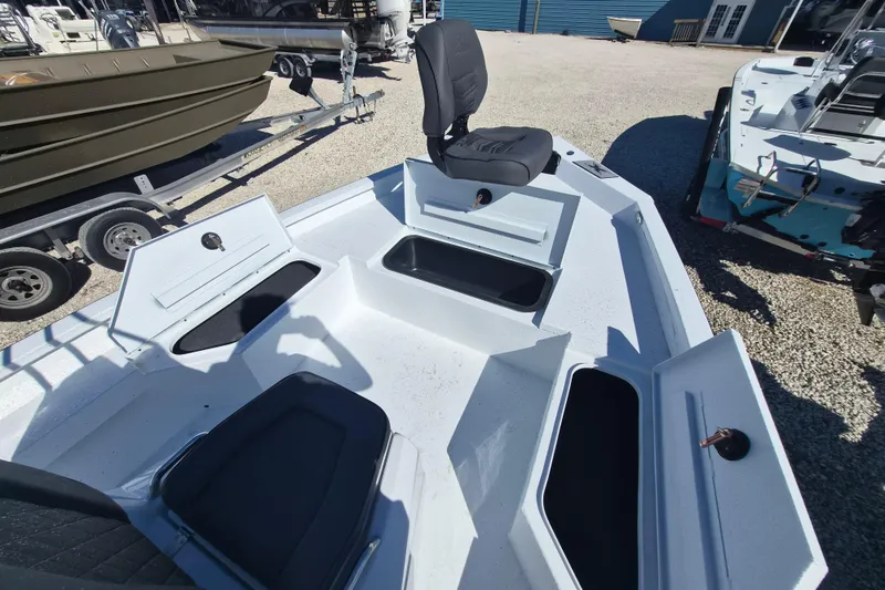 Slide: The Image of 2026 Xpress H20B Bay boat with open storage compartments and seating. - 12