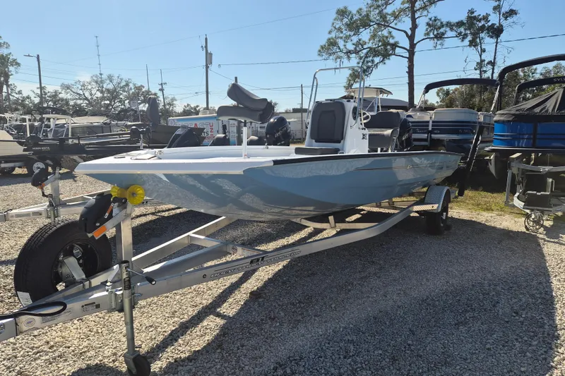 Slide: The Image of 2026 Xpress H20B Bay boat on trailer, displayed outdoors in a dealership lot. - 3