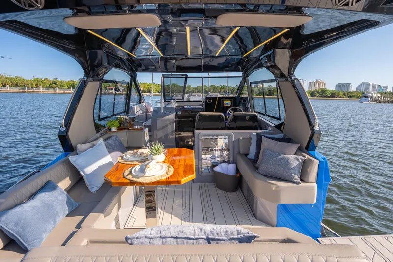 Slide: The Image of Luxurious 2026 Hanover 347 yacht interior with elegant seating and dining area on the water. - 17