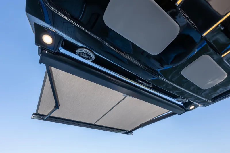 Slide: The Image of 2026 Hanover 347 RV with extended awning and integrated lighting, viewed from below. - 20