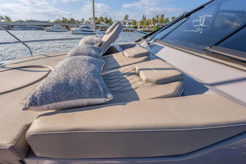 Slide: The Image of Luxurious Hanover 347 yacht deck with cushions, 2026 model, docked by waterfront homes. - 38