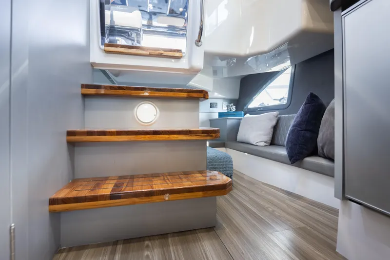 Slide: The Image of Interior of 2026 Hanover 347 yacht with wooden steps and cozy seating area. - 47