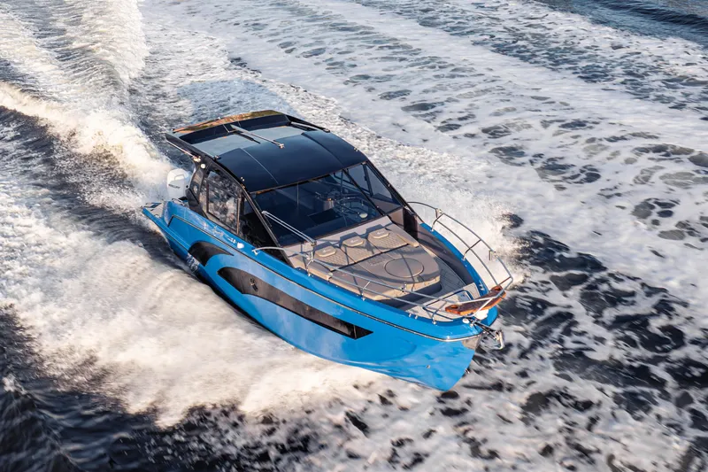 Slide: The Image of Modern Hanover 347 boat cruising on open water, 2026 model, sleek blue design. - 7