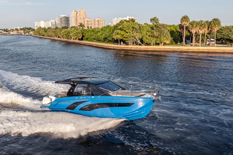 Slide: The Image of 2026 Hanover 347 boat cruising on a scenic waterway with city skyline backdrop. - 8