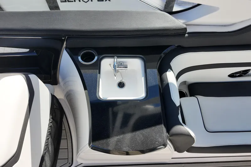 Slide: The Image of 2024 Yamaha Boats 275SE interior with sink and seating area. - 16