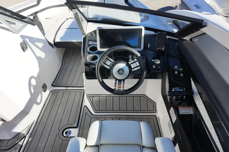 Slide: The Image of 2024 Yamaha Boats 275SE cockpit with modern steering and dashboard controls. - 7