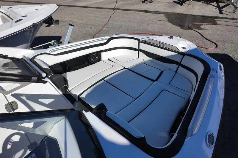 Slide: The Image of 2024 Yamaha Boats 275SE interior with sleek white seating and black accents. - 8