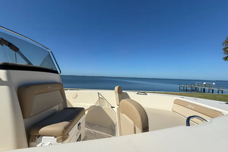 Slide: The Image of 2026 Scout 195 Sportfish boat interior with scenic waterfront view. - 26