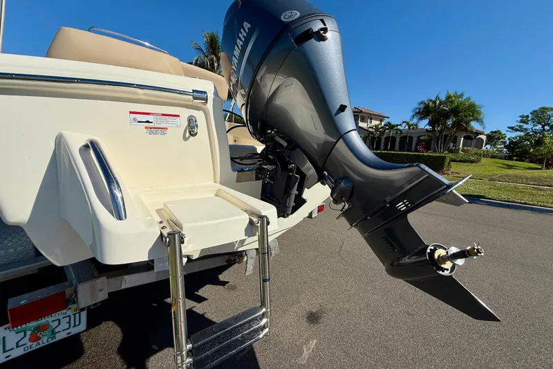 Slide: The Image of 2026 Scout 195 Sportfish boat with Yamaha outboard motor and swim ladder. - 7