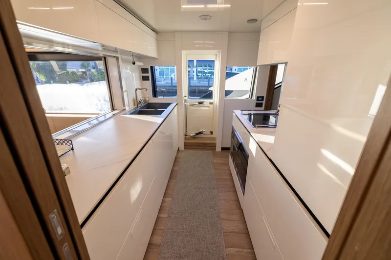 Slide: The Image of Modern kitchen interior of 2021 Ferretti Yachts 920, featuring sleek white cabinetry and appliances. - 10