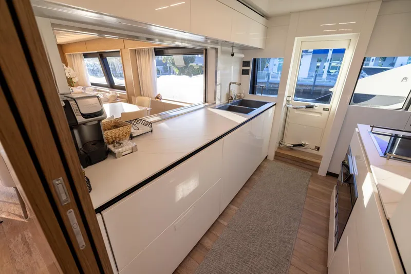 Slide: The Image of Modern kitchen interior on 2021 Ferretti Yachts 920, featuring sleek design and ample natural light. - 11