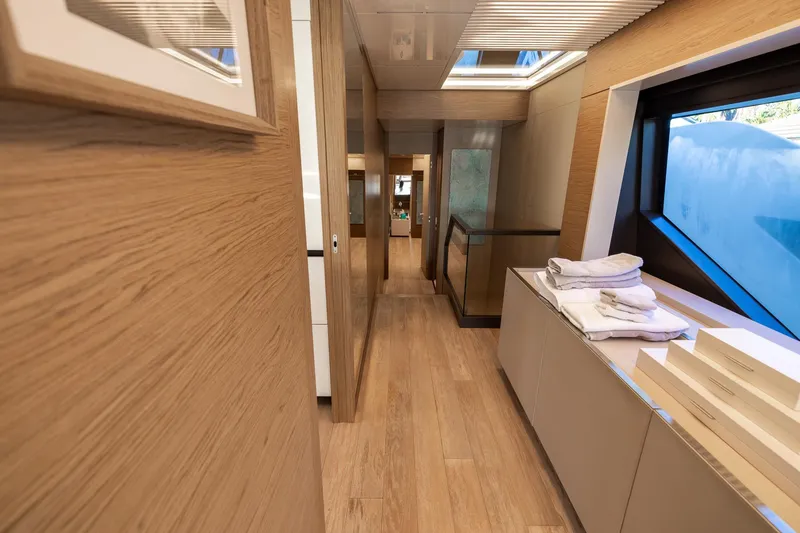 Slide: The Image of Luxurious interior of 2021 Ferretti Yachts 920 with modern wood finishes and large windows. - 13