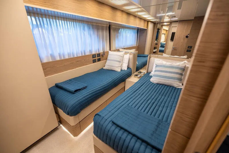 Slide: The Image of Luxurious twin cabin interior on 2021 Ferretti Yachts 920 with blue bedding. - 27