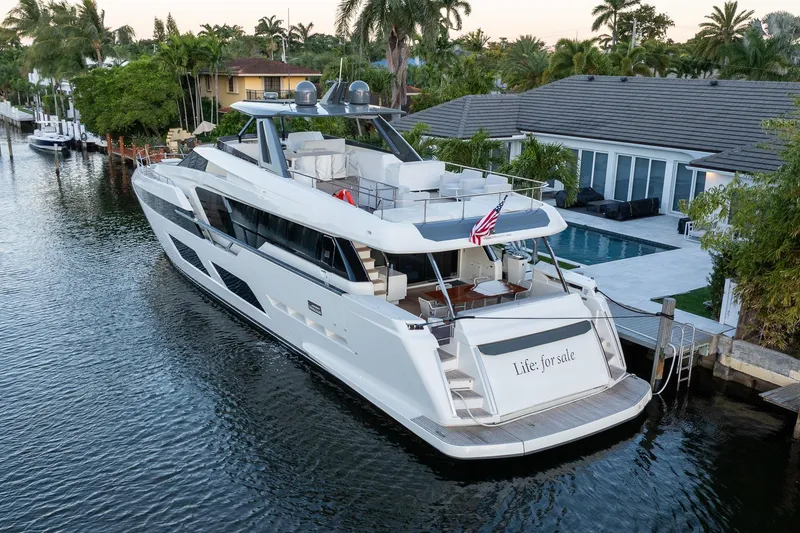 Slide: The Image of 2021 Ferretti Yachts 920 docked by a luxurious waterfront home. - 39