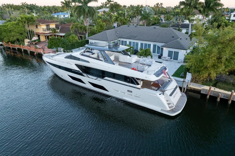 Slide: The Image of Luxurious 2021 Ferretti Yachts 920 docked by a waterfront home, surrounded by lush greenery. - 43