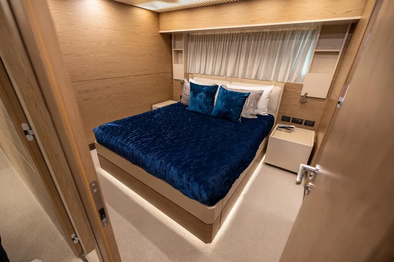 Slide: The Image of Luxurious bedroom interior of 2021 Ferretti Yachts 920 with elegant blue bedding. - 24