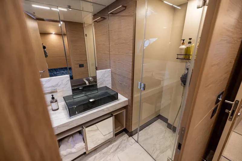 Slide: The Image of Luxurious bathroom in 2021 Ferretti Yachts 920 with modern glass shower and marble sink. - 26