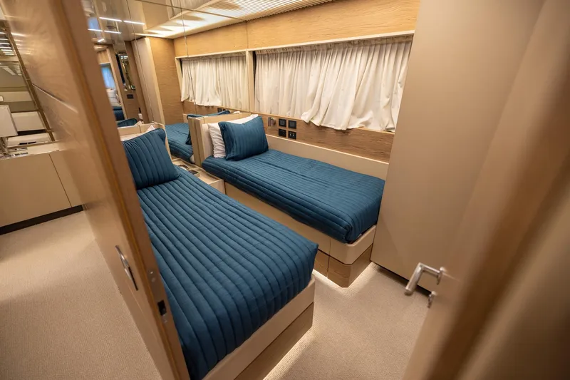 Slide: The Image of Luxurious twin cabin interior of 2021 Ferretti Yachts 920 with blue bedding. - 28