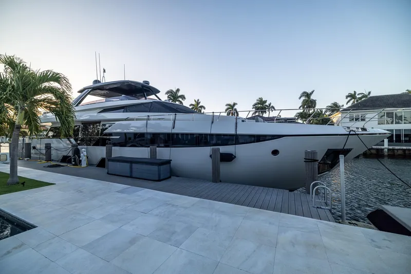 Slide: The Image of 2021 Ferretti Yachts 920 docked, surrounded by palm trees and waterfront views. - 6