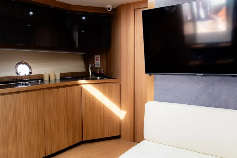 Slide: The Image of Interior of 2013 Azimut Atlantis 48 yacht with modern kitchen and TV. - 24
