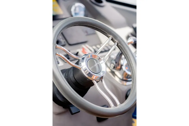 Slide: The Image of Steering wheel of 2013 Azimut Atlantis 48 yacht, showcasing sleek design and controls. - 25