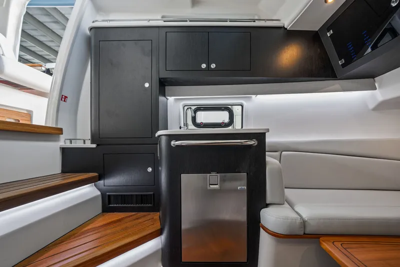 Slide: The Image of Interior of the 2026 Boston Whaler 380 Realm with sleek wood flooring and modern cabinetry. - 27