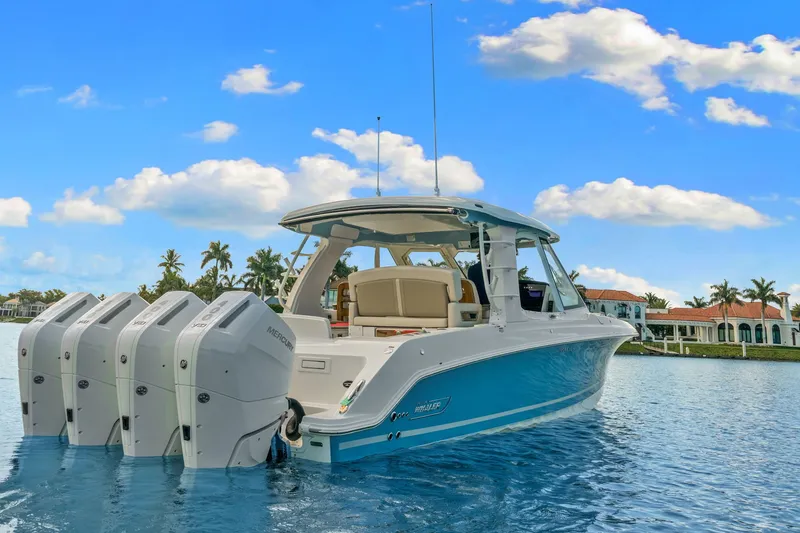 Slide: The Image of Boston Whaler 380 Realm 2026 on calm water with four outboard engines and a luxurious cockpit. - 16