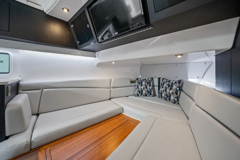Slide: The Image of Interior of a modern yacht with sleek gray upholstery and a wooden table. - 29