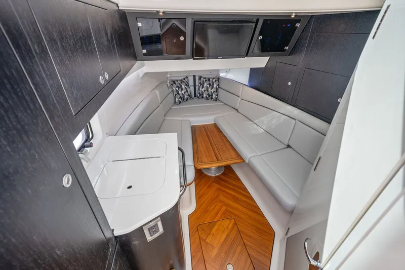 Slide: The Image of Interior of the 2026 Boston Whaler 380 Realm with sleek seating area and wooden table. - 28