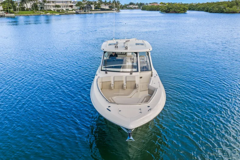 Slide: The Image of 2026 Boston Whaler 380 Realm on calm water, featuring a spacious deck and sleek cabin. - 3