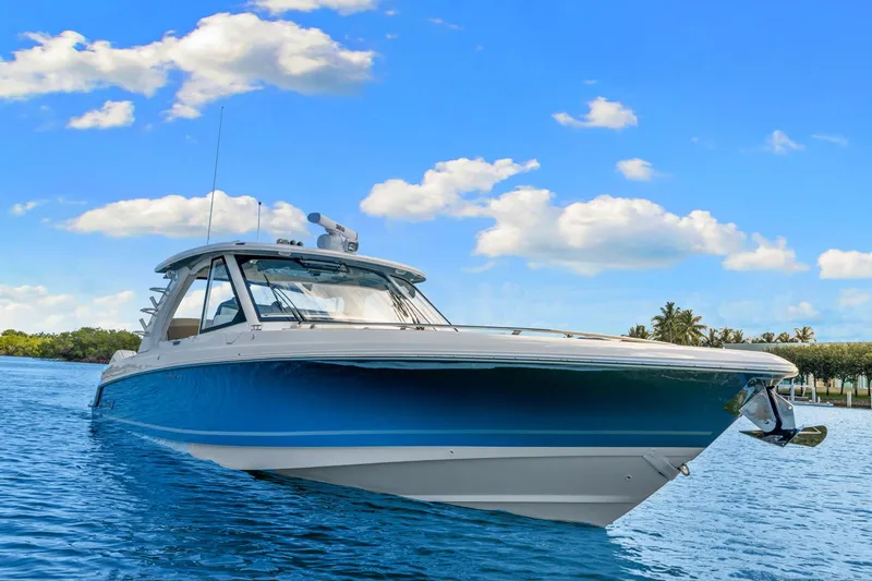 Slide: The Image of 2026 Boston Whaler 380 Realm on calm water under a blue sky. - 8