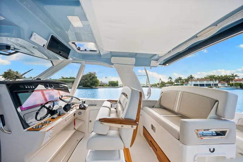 Slide: The Image of The image shows the cockpit of a 2026 Boston Whaler 380 Realm with luxurious seating and modern electronics. - 23