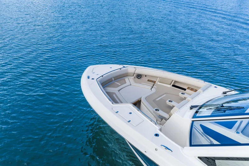 Slide: The Image of The 2026 Boston Whaler 380 Realm features a sleek design with a spacious bow area on calm water. - 10
