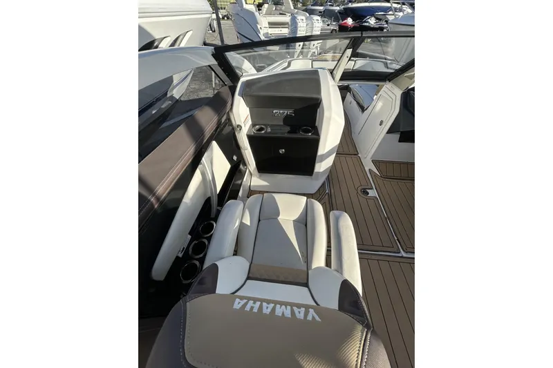 Slide: The Image of 2021 Yamaha Boats 275SE interior with seating and dashboard, showcasing luxury design. - 15
