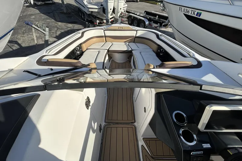 Slide: The Image of 2021 Yamaha Boats 275SE interior with sleek seating and modern dashboard design. - 7
