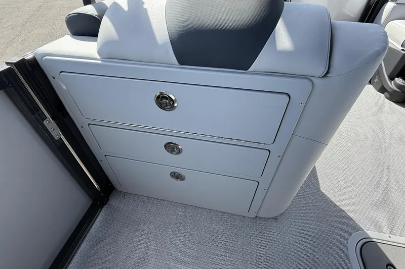 Slide: The Image of 2026 Avalon 2385 LSZ Tri Toon boat storage drawers and seating detail. - 14
