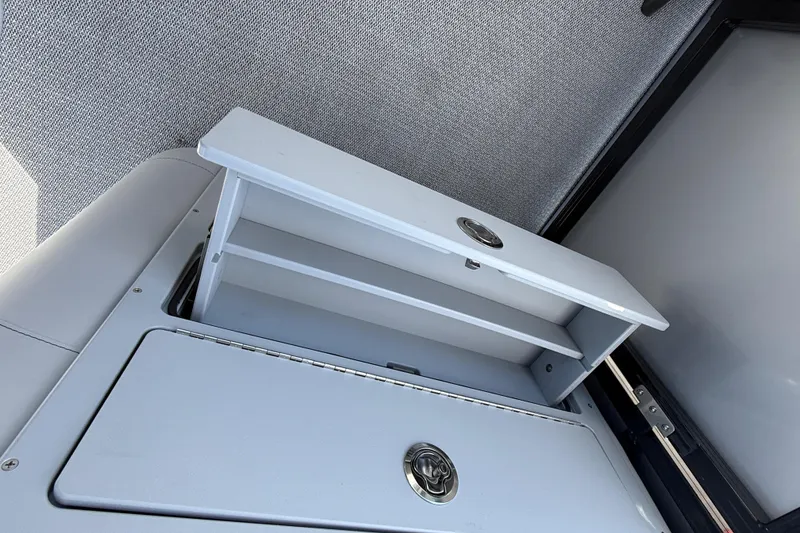 Slide: The Image of 2026 Avalon 2385 LSZ Rear Fish Tri Toon storage compartment, open and empty. - 16