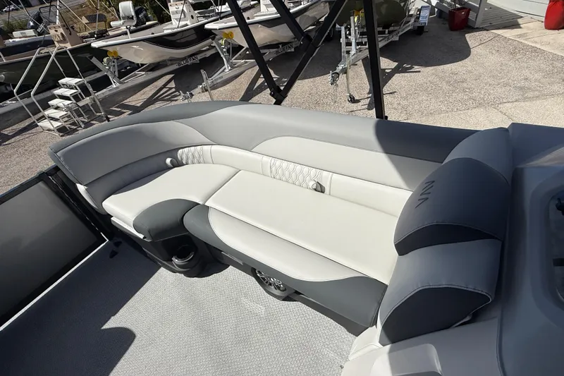 Slide: The Image of 2026 Avalon 2385 LSZ Tri Toon boat with luxurious rear seating in a showroom. - 18