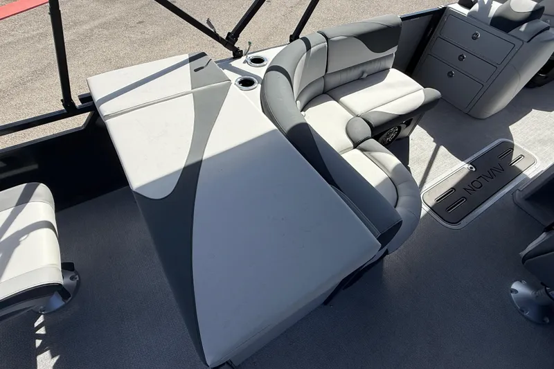 Slide: The Image of 2026 Avalon 2385 LSZ Rear Fish Tri Toon interior with plush seating and storage compartments. - 25