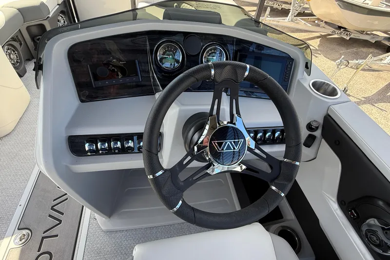 Slide: The Image of Steering console of 2026 Avalon 2385 LSZ Rear Fish Tri Toon boat, featuring modern controls. - 27