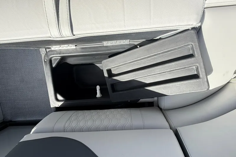 Slide: The Image of 2026 Avalon 2385 LSZ Tri Toon boat storage compartment with open lid, showcasing interior space. - 29