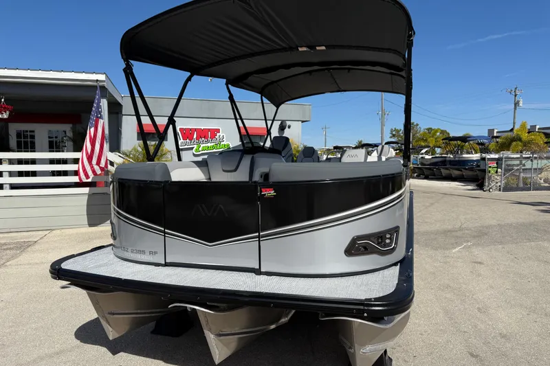 Slide: The Image of 2026 Avalon 2385 LSZ Rear Fish Tri Toon boat at dealership, showcasing sleek design. - 3