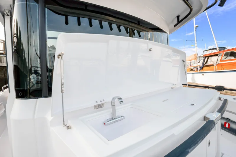 Slide: The Image of 2021 Axopar 37 XC Cross Cabin boat with sleek outdoor sink area. - 14
